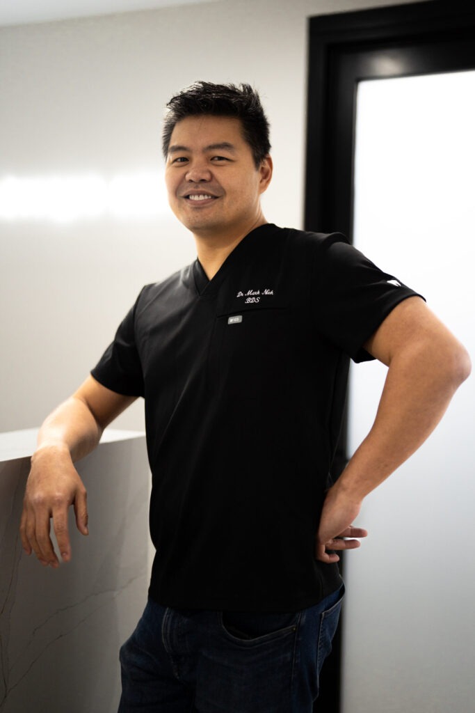 Portrait of a dental practitioner in black scrubs
